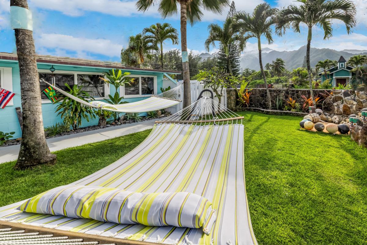 Drift into tropical bliss on your private hammock, surrounded by swaying palms and mountain vistas in this lush garden paradise.