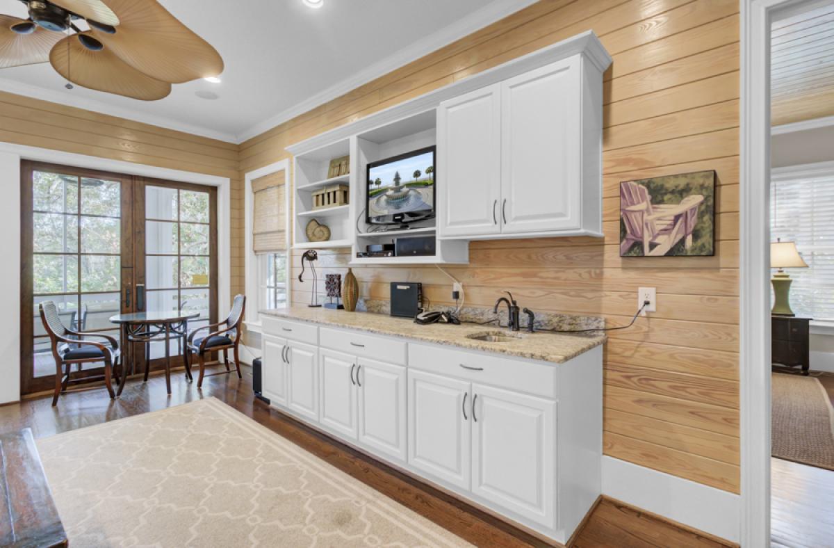 Your spacious kitchenette features white cabinetry, granite counters, and entertainment center—perfect for preparing meals while staying connected.