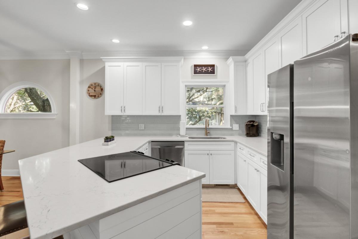 Your modern kitchen features crisp white cabinets, quartz countertops, and stainless steel appliances for effortless meal preparation.