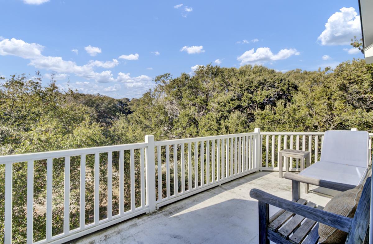 Your private balcony invites you to unwind with morning coffee while gazing over lush treetops stretching toward rolling hills.