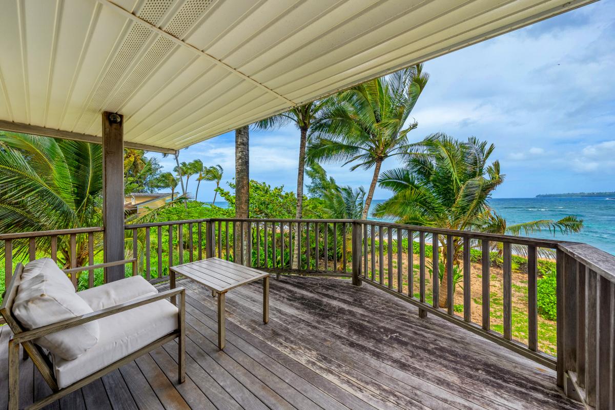Relax on your private covered lanai with ocean views, swaying palms, and comfortable seating for the perfect tropical escape.