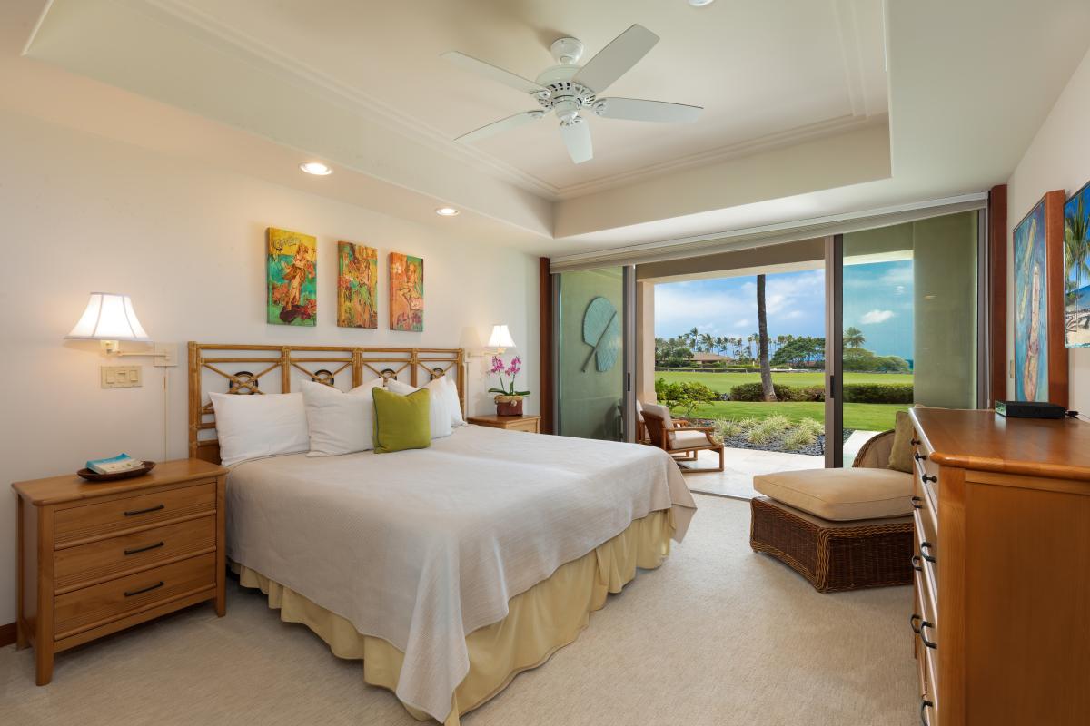 Drift off to sleep in this serene King bedroom where comforting breezes flow through sliding doors and lush garden views greet you each morning.