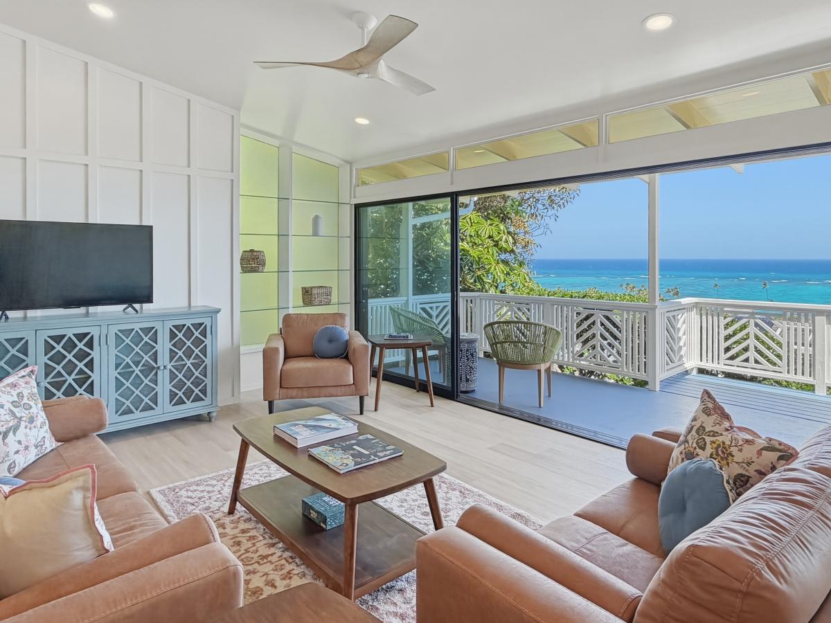 Your calm oceanfront retreat with panoramic sea views through floor-to-ceiling windows. Relax on plush seating while ocean breezes flow through.