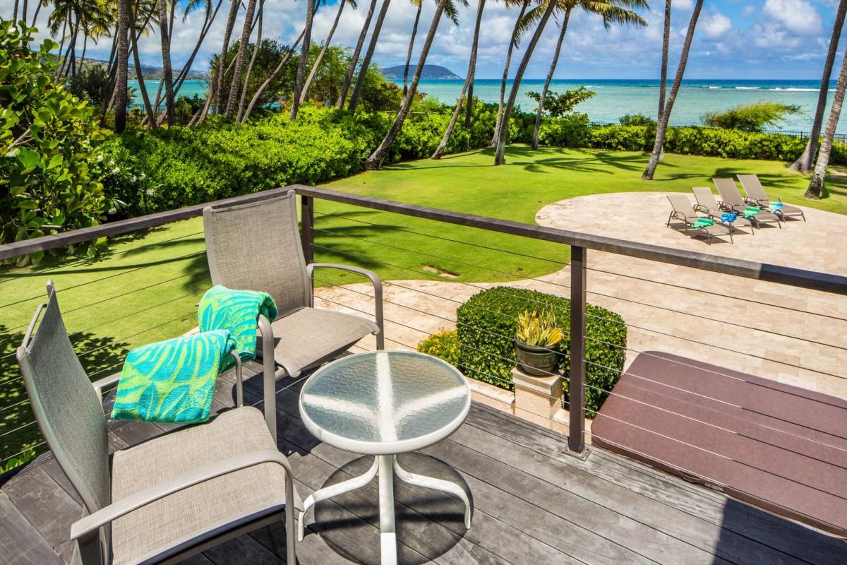 Sip morning coffee on the lanai with ocean views and swaying palm trees below.