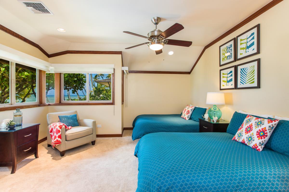 Settle into this comfortable guest room with two beds and soft natural light.