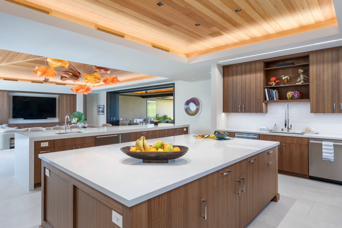 This stunning open kitchen invites you to create culinary masterpieces with premium appliances and elegant wood finishes.