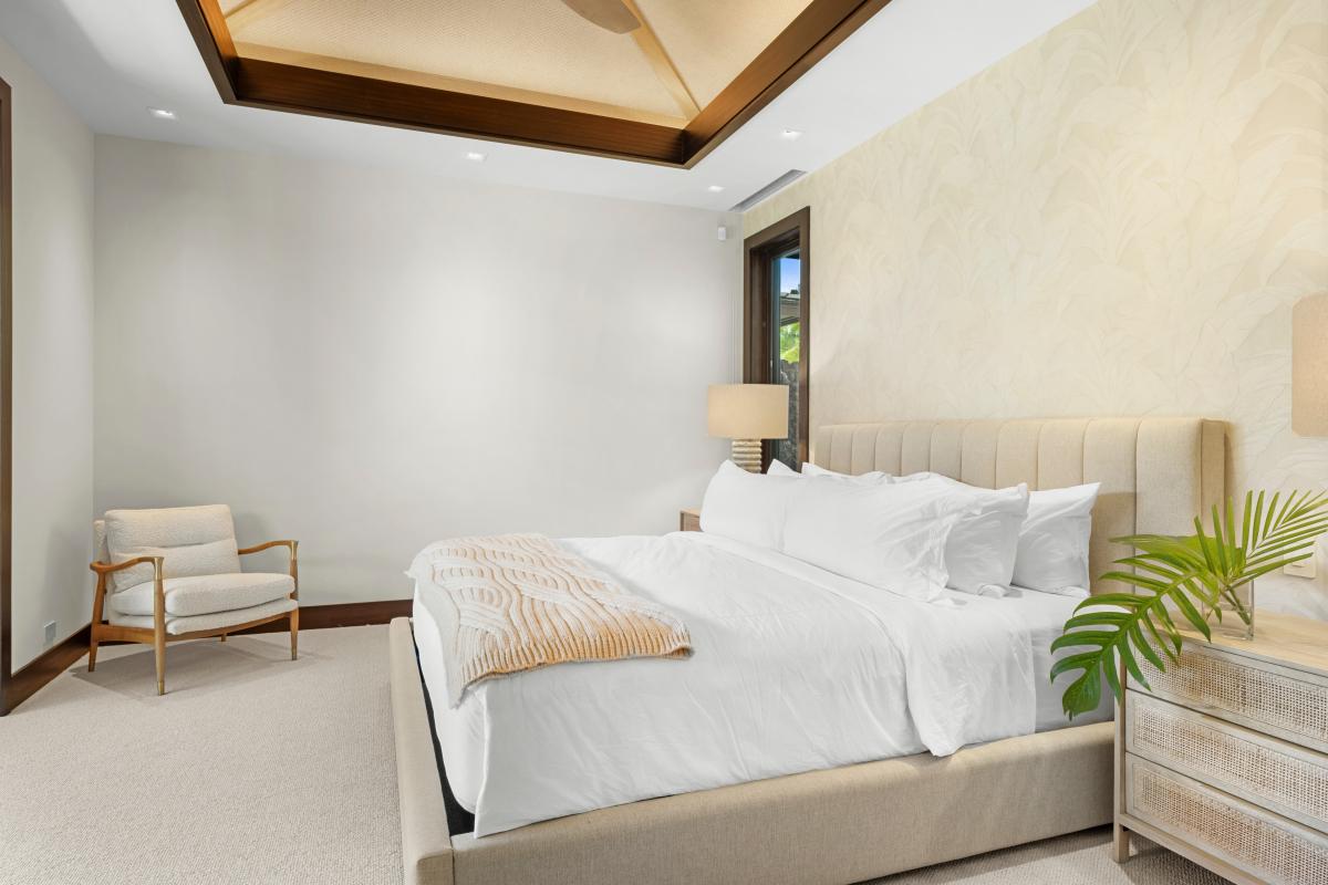 Guest Bedroom #4: Sink into crisp white linens and enjoy the serene ambiance of your elegant bedroom, featuring beautiful coffered ceilings and modern comfort.