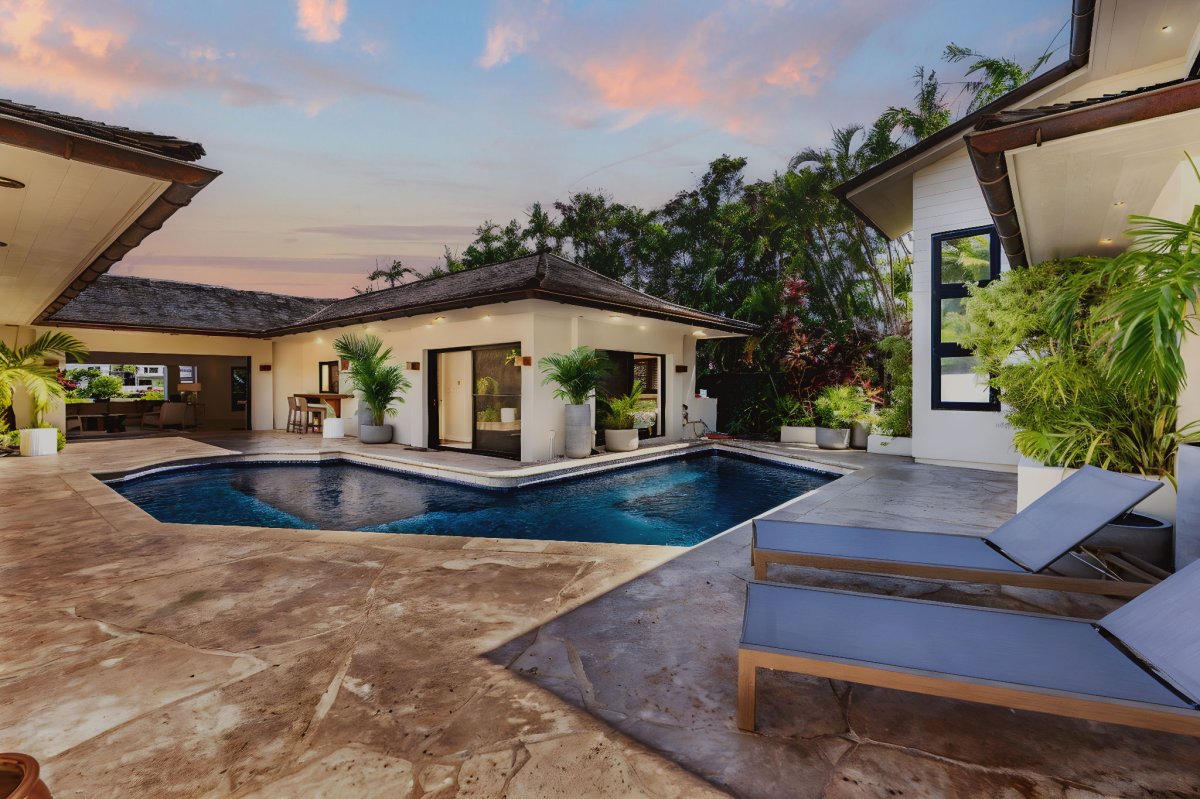 Evening light over the pool courtyard, settling softly across tropical surroundings.