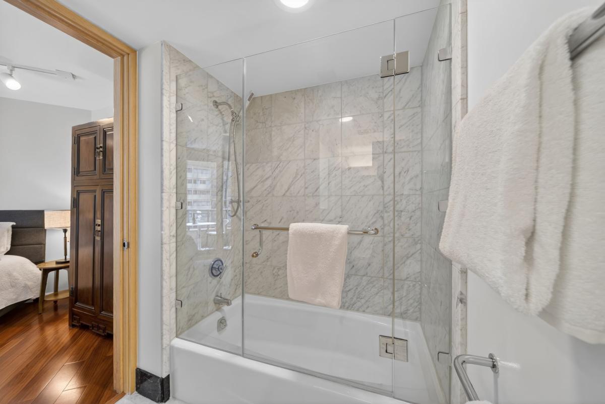 Enjoy spa-inspired comfort with a soaking tub and glass-enclosed rainfall shower.