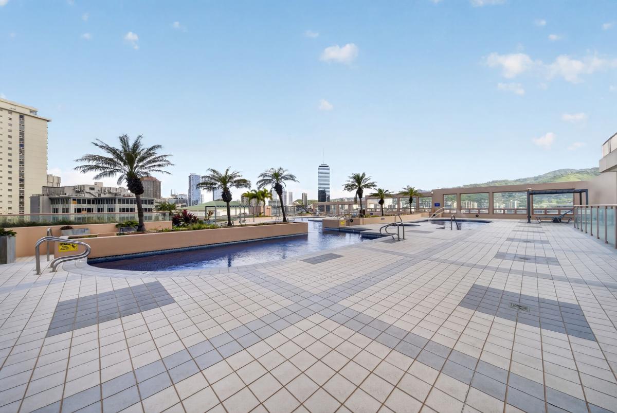 Lounge above the city on the expansive rooftop recreation deck with skyline views.