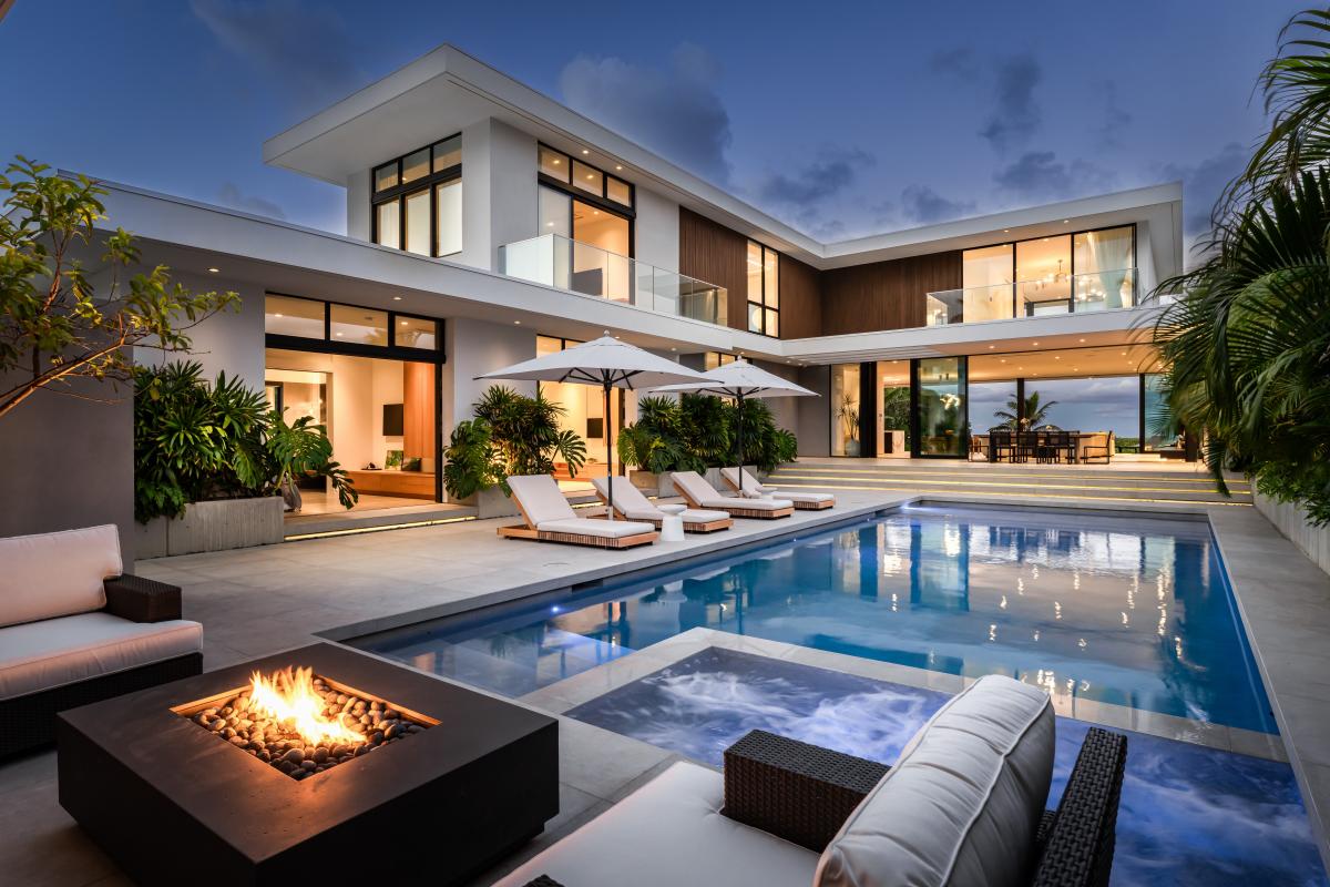 Sink into the evening as your private pool terrace glows beneath the Kailua sky.