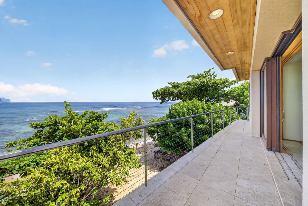 The wraparound lanai offers multiple vantage points to soak in panoramic shoreline views and unforgettable North Shore sunsets.