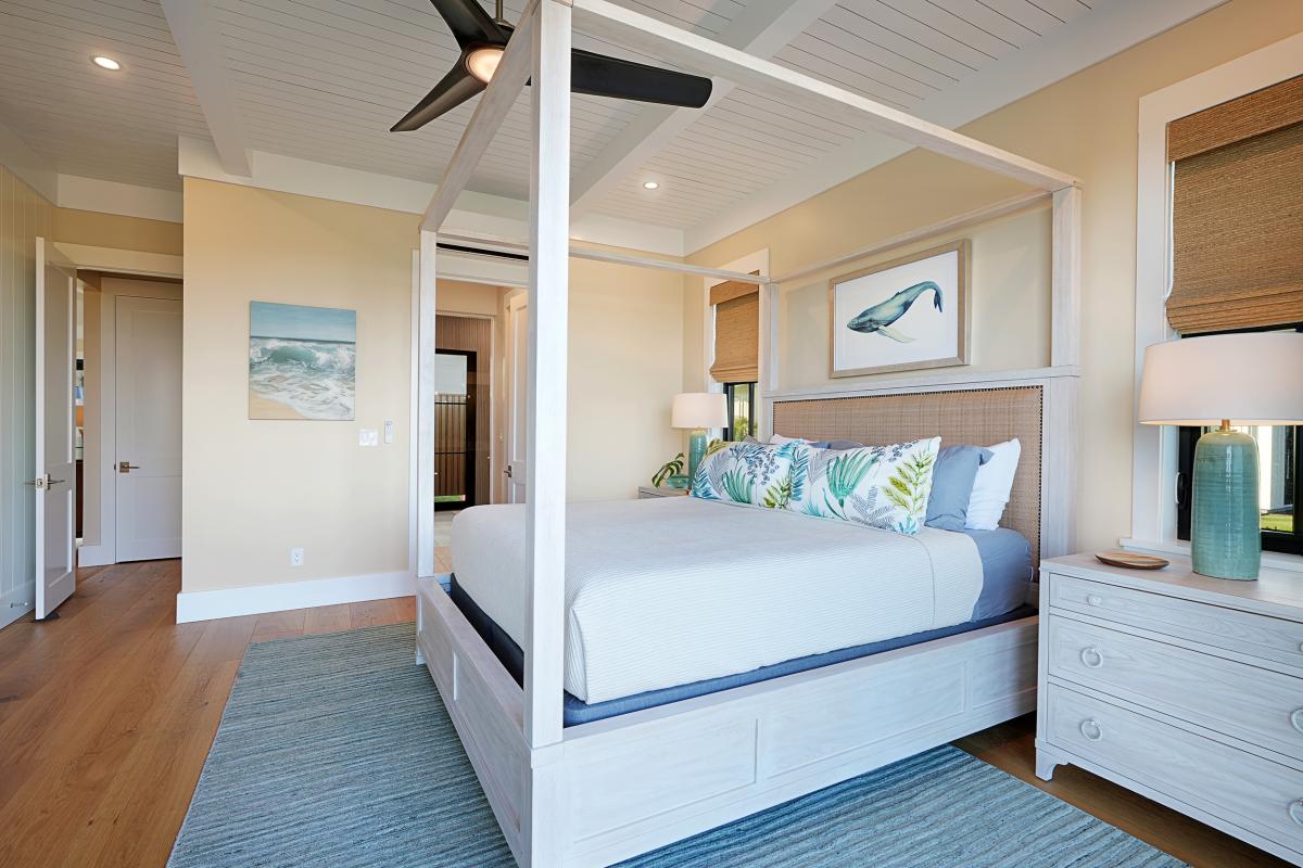 A four-poster bed and a wall of glass keep this room bright and turned toward the view.