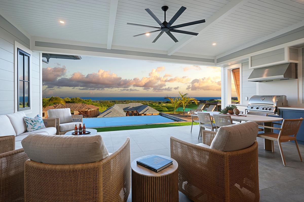 The lanai opens wide to the pool and the ocean beyond, where most days here begin and end.