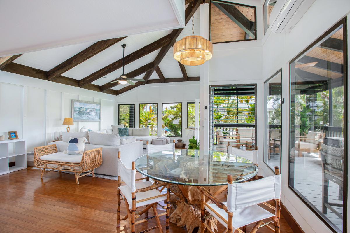 Enjoy shared meals beneath soaring ceilings in the open-concept dining room with garden views.
