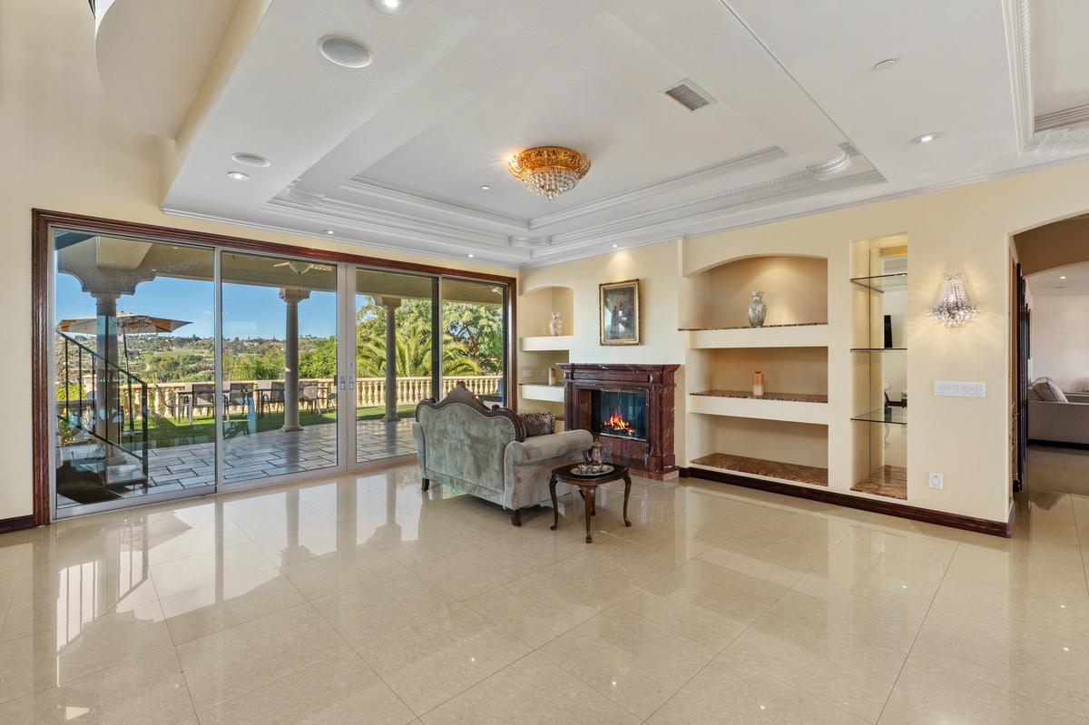 This room opens to the view, coffered ceiling overhead and glass all around.