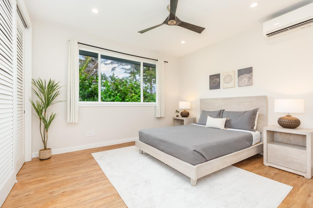 In Guest Bedroom 3 with queen bed, located on the second floor, the soft light and views of lush greenery through the window make this room an easy place to land.
