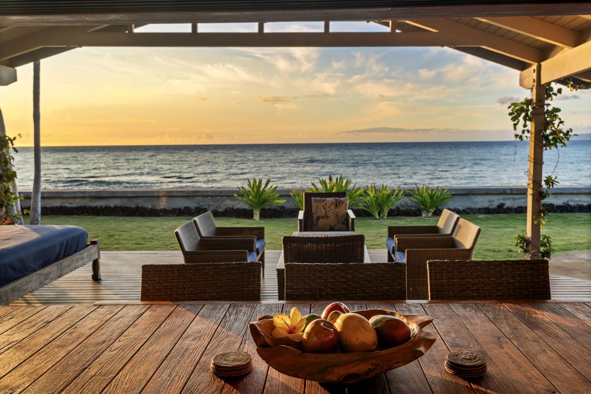 A bowl of fruit out on the deck, loungers turned toward the fading light.