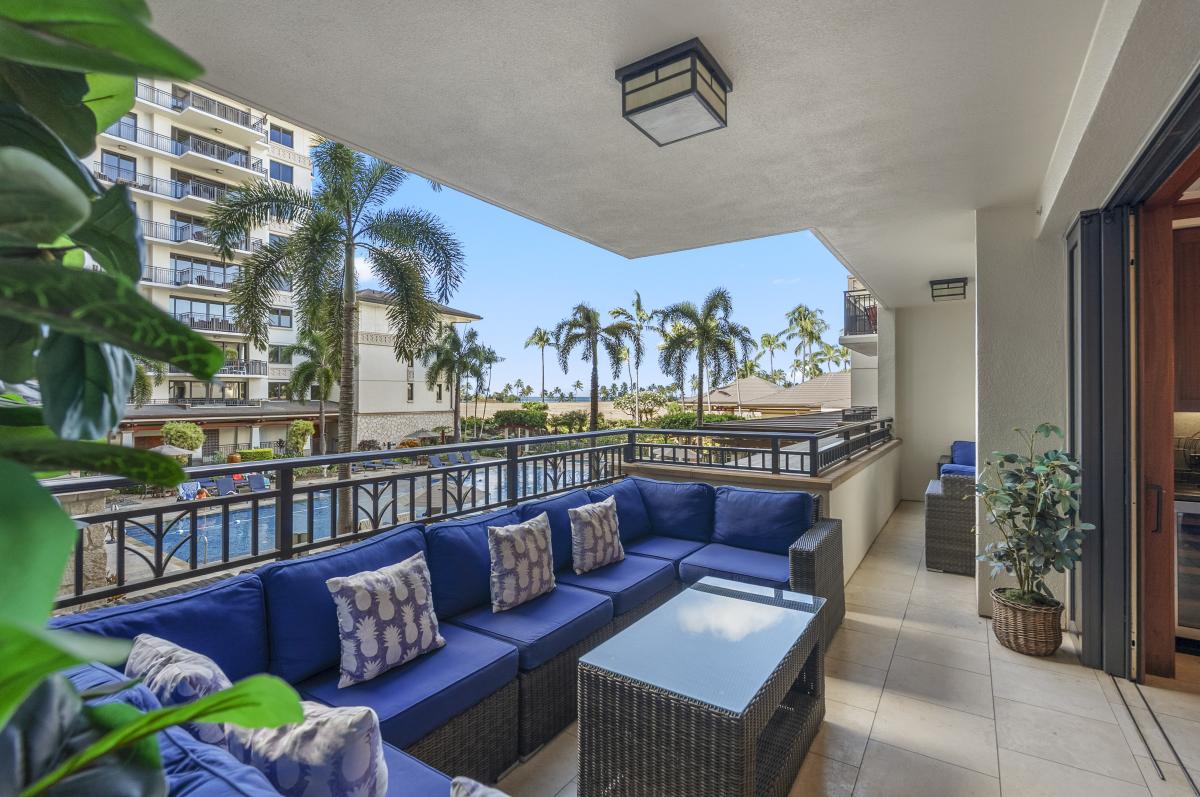 Take the shaded end of the lanai first, where the deep overhang keeps the sun off the sectional all afternoon.