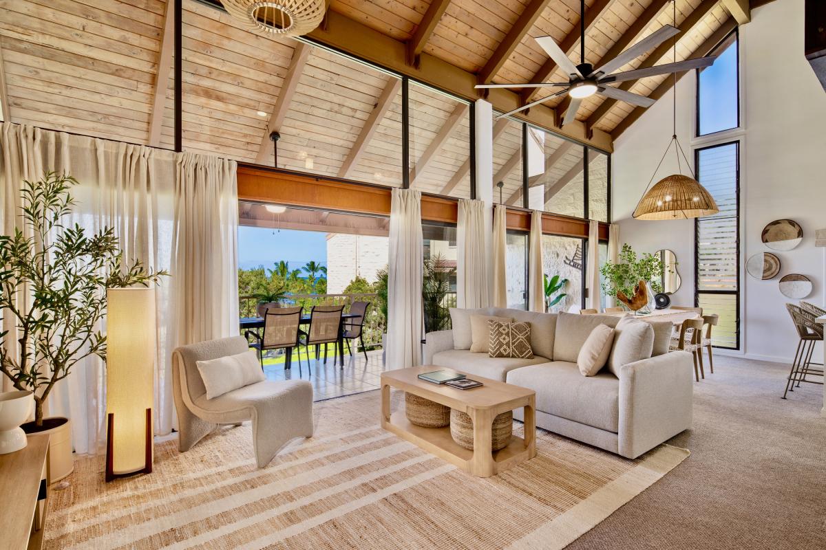 Settle into the great room, where vaulted beams lift the ceiling and the doors stay open.