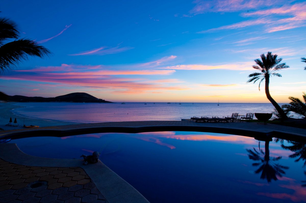 Pool with ocean view during sunset